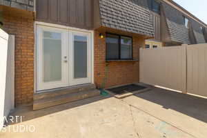 Doorway to property featuring french doors and a patio area