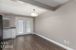 Unfurnished dining area featuring french doors, dark hardwood / wood-style flooring, and beam ceiling