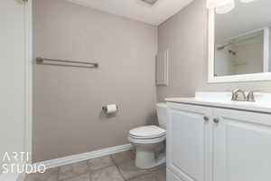 Bathroom with vanity, tile patterned floors, and toilet