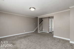 Interior space featuring carpet floors and ornamental molding