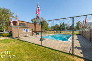 View of swimming pool with a lawn