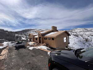 View of snowy exterior featuring a mountain view