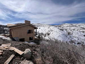 Snow covered property featuring a mountain view