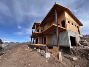 View of side of property featuring a balcony and a mountain view