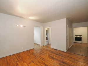 Spare room featuring dark hardwood / wood-style floors