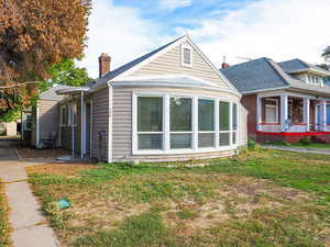 View of side of home featuring a yard