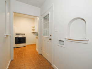 Hallway with tile patterned flooring