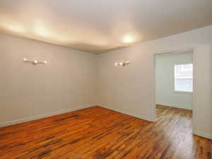 Empty room with hardwood / wood-style flooring