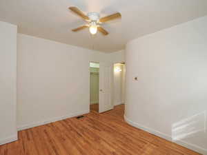 Empty room featuring light hardwood / wood-style flooring and ceiling fan