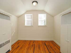 Bonus room featuring radiator, lofted ceiling, and dark hardwood / wood-style floors