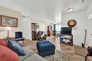 Living room featuring light wood-type flooring and ceiling fan