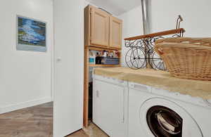 Washroom with light wood-type flooring and cabinets