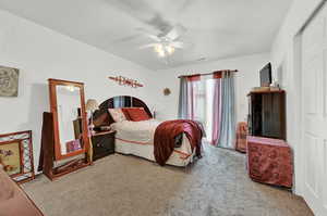 Bedroom featuring light carpet, a closet, and ceiling fan