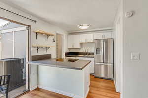 Light and bright kitchen, dining area, and living room with NEW (2024) vinyl flooring