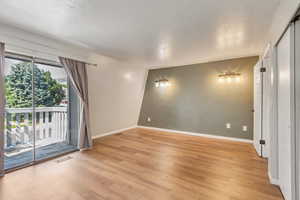 *See Virtually Staged Photo*  North facing bedroom with sliding glass door and outside balcony