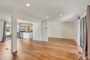 Light and bright kitchen, dining area, and living room with NEW (2024) vinyl flooring