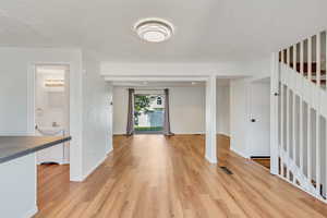 Light and bright kitchen, dining area, and living room with NEW (2024) vinyl flooring