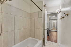 Updated bathroom featuring tiled shower / bath combo