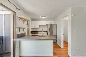 Light and bright kitchen, dining area, and living room with NEW (2024) vinyl flooring