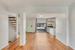 Light and bright kitchen, dining area, and living room with NEW (2024) vinyl flooring