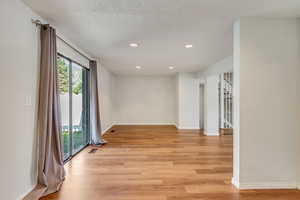 Light and bright kitchen, dining area, and living room with NEW (2024) vinyl flooring