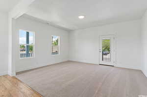 Unfurnished room featuring light colored carpet