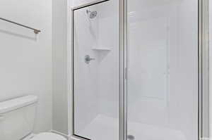 Bathroom with an enclosed shower and toilet