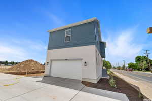 View of property exterior featuring a garage