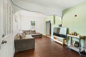 Living room with hardwood / wood-style flooring and cooling unit