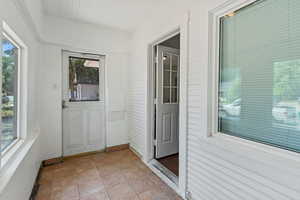 Unfurnished sunroom featuring plenty of natural light