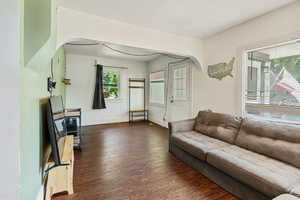 Living room with dark hardwood / wood-style flooring