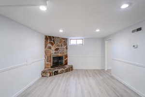 Unfurnished living room with new light hardwood / wood-style floors and a fireplace