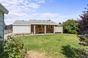 Back of house featuring a patio and a lawn