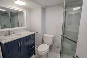 Bathroom with tile patterned flooring, toilet, and vanity