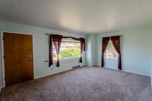 Empty room featuring carpet flooring