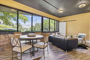 Dining room with a mountain view, a barn door, and wood-type flooring