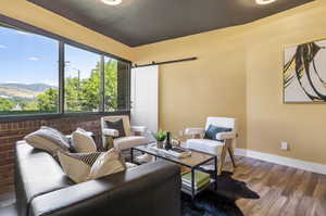 Living room with wood-type flooring and a barn door