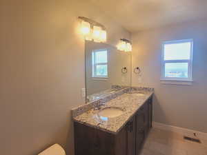 Bathroom featuring dual vanity and tile patterned flooring