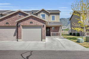 View of front of property with a garage and a mountain view