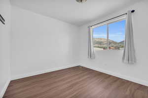 Empty room featuring hardwood / wood-style flooring