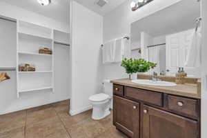 Bathroom with vanity, tile patterned flooring, and toilet