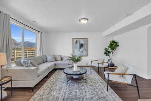 Living room with dark wood-type flooring and a mountain view