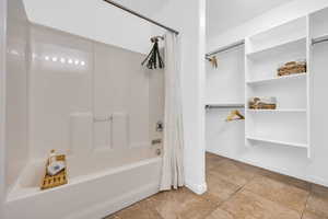 Bathroom featuring tile patterned floors and shower / tub combo