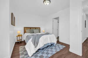 Bedroom with dark wood-type flooring