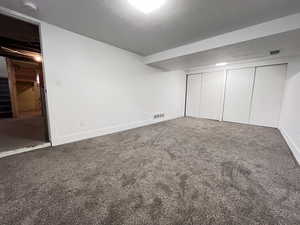 Unfurnished bedroom with carpet and a closet