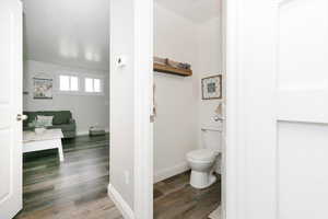 Bathroom with toilet and hardwood / wood-style floors