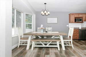 Dining room featuring hardwood / wood-style floors and a chandelier