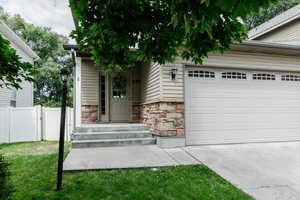 Doorway to property featuring a lawn