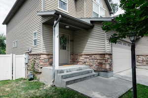 Doorway to property with a garage