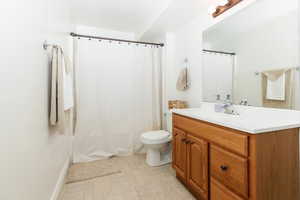 Bathroom with tile patterned flooring, toilet, and vanity